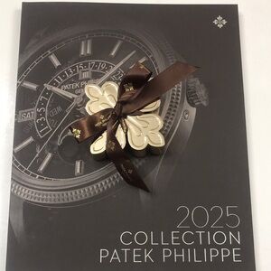 Patek Philippe 2025 Collection gold paperweight.